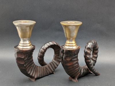 pair of antique brass candlesticks with horns and horns on them