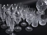 a lot of wine glasses and a pitcher on the table
