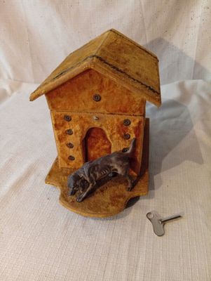 un chat assis à l'intérieur d'une petite maison