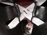a close up of a helmet with a pair of scissors attached to it