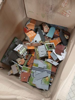 a cardboard box filled with assorted toys and other items