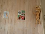 a picture of a book on the wall next to a figurine