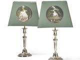 pair of lamps with a picture of a park scene on the lampshade