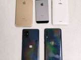 four iphones are lined up in a row on a white surface