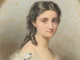 portrait of a woman in a white dress with braids and a blue bow