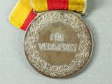a medal with a ribbon around it on a table
