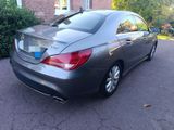 the back of a mercedes cla parked in front of a house