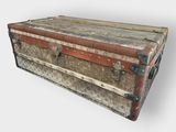 an old trunk sitting on top of a white surface