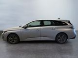 the silver car is parked in a large room with a white wall