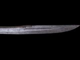 a knife that is sitting on a black surface