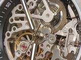 a close up of a watch with a metal case