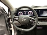 the interior of a car with a steering wheel and dashboard controls
