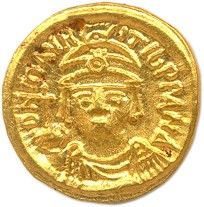 une pièce d'or à l'effigie d'un homme coiffé d'un chapeau
