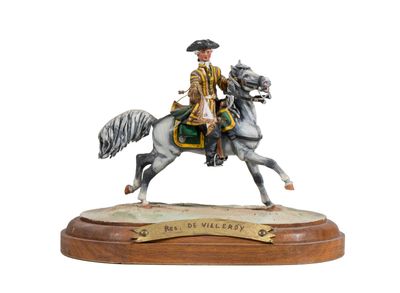 figurine of a man riding a horse on a wooden base