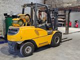 a yellow forklift truck parked in a warehouse