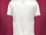 a white shirt on a mannequin stand against a red background