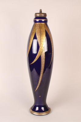 a blue vase with a gold leaf design on it