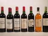 several bottles of wine are lined up in a row on a table