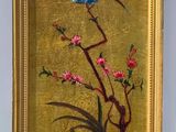 painting of a bird on a branch with flowers in a gold frame
