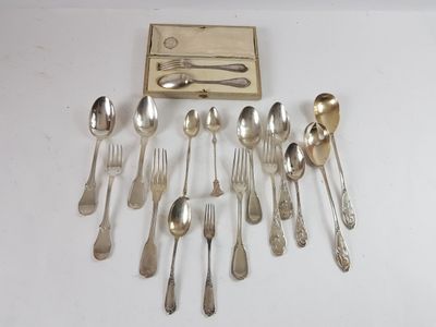 a lot of silver spoons and spoons on the table