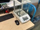 une photo d'un bureau sur lequel se trouvent un ordinateur et une balance