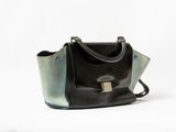 black and green handbag on white background with white background