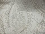 a close up of a bed with a white comforter on top of it