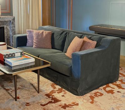 a living room with a couch, coffee table and a fireplace