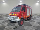 a red fire truck that is parked on a checkered floor