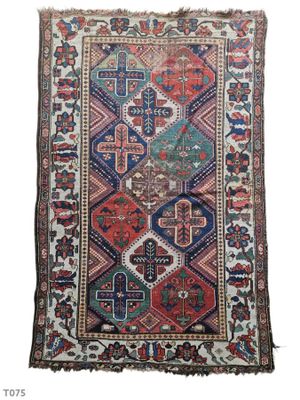 an antique rug with a multicolored design on a white background
