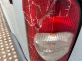 the rear end of a car with a broken tail light