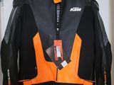 an orange and black jacket hanging on a hanger in a room