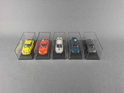 five cars are lined up in a row in a display case