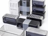 several plastic containers with lids are lined up on a white surface