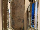a mirror hanging on the wall above a sink