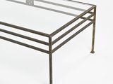 a glass table with metal legs and a glass top