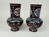 two vases that are sitting on a table