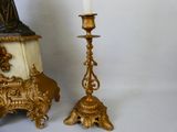 une bougie posée à côté d'une statue sur une table