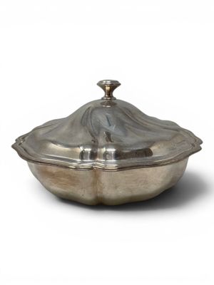 an antique silver plate covered dish with a lid on a white background