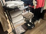 a rack of clothes in a clothing store with clothes on it