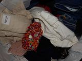a pile of clothes that is sitting on the floor