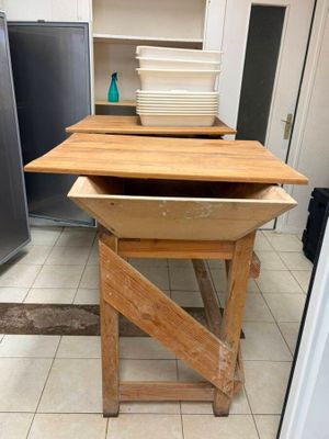 a wooden table with a bowl on it in a kitchen
