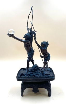 a statue of a man and a boy holding a light bulb