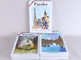three books are sitting on a table with a white background
