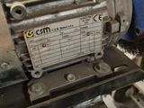 an image of a machine that is working on a piece of metal