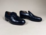 a pair of black leather shoes on a white background