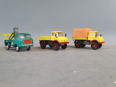 three toy trucks that are sitting next to each other