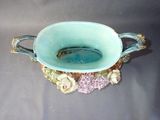 a blue bowl with flowers on it sitting on a table
