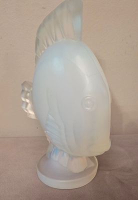 a glass fish head on a stand on a table