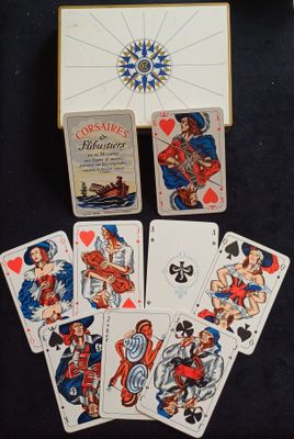 une boîte de cartes à jouer posée sur une table à côté d'une autre boîte de cartes à jouer